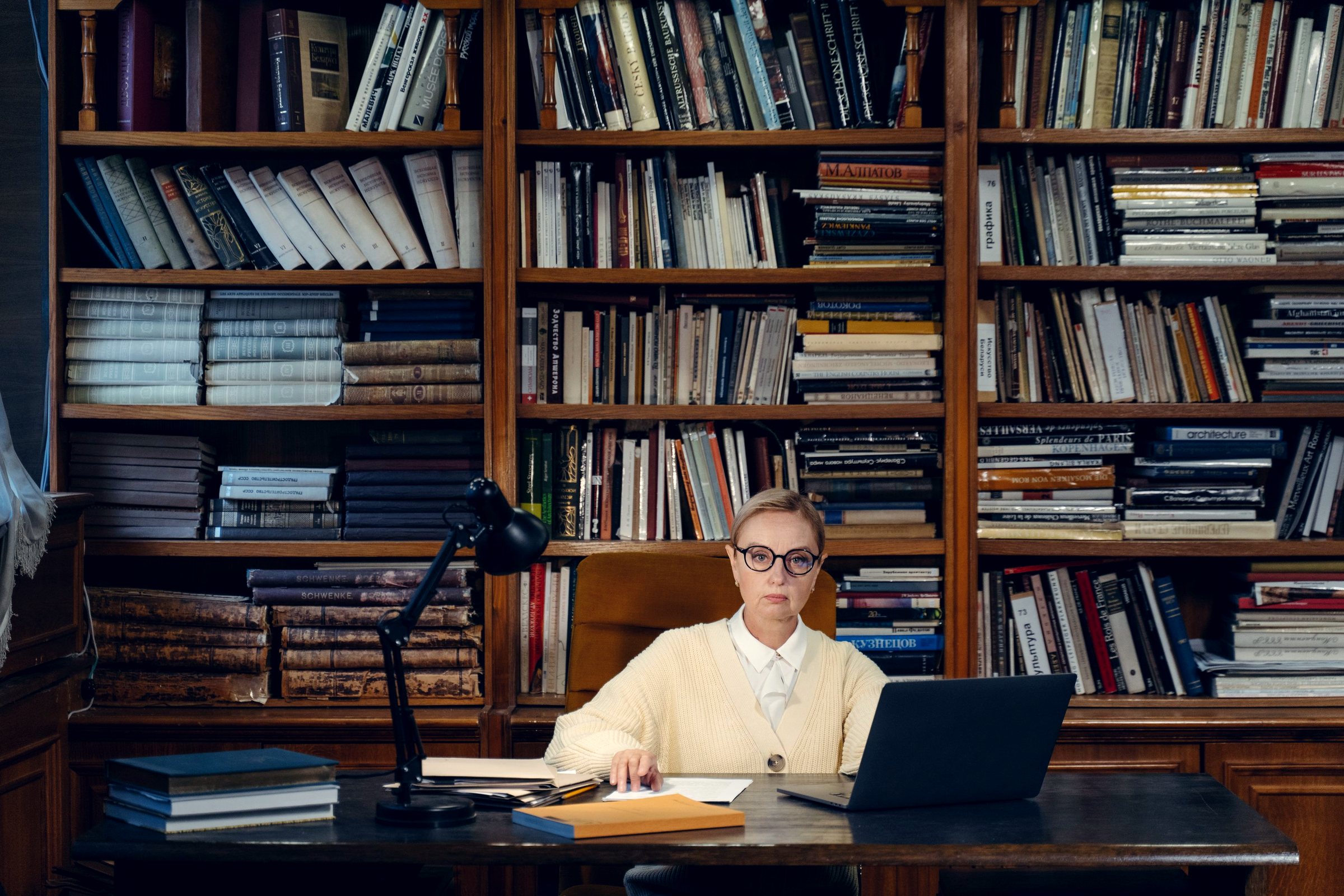 A man studying on a laptop in a blue-panelled lounge
