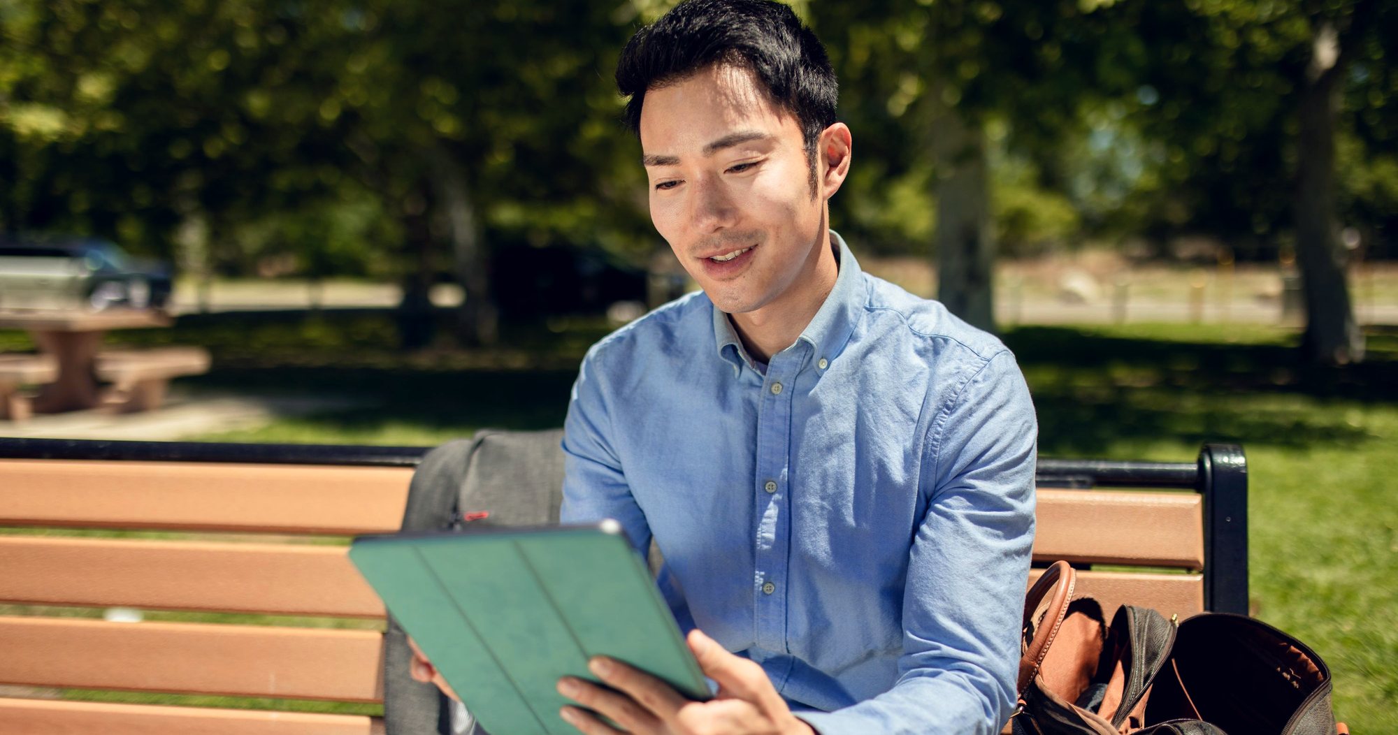 A man reading on a tablet in a quiet interior